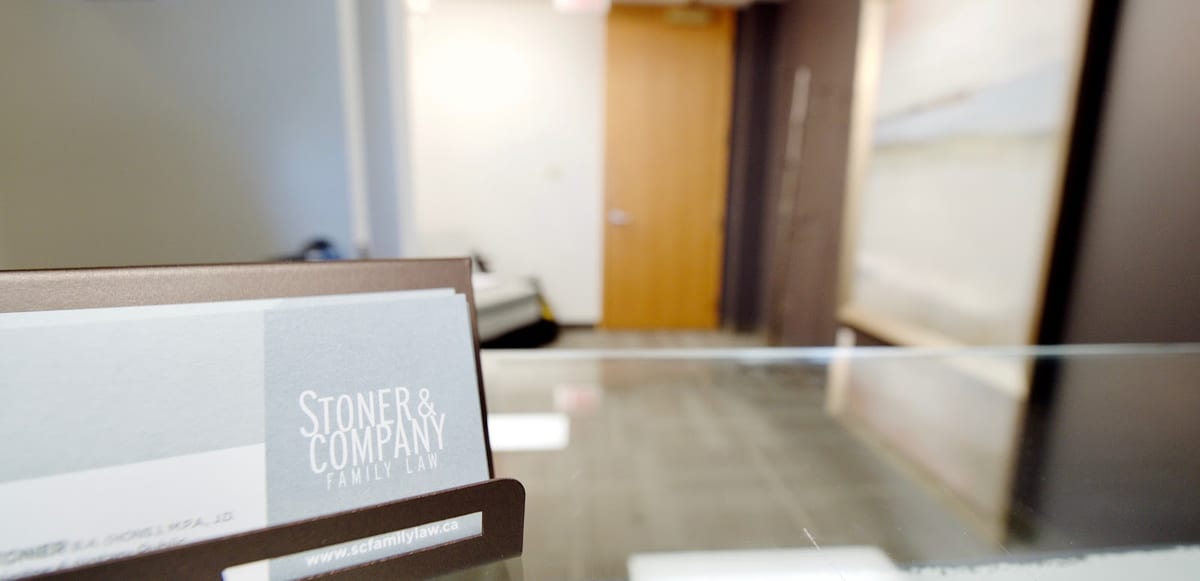 The reception desk at Stoner & Company Family Law, with the firm's business cards on the counter