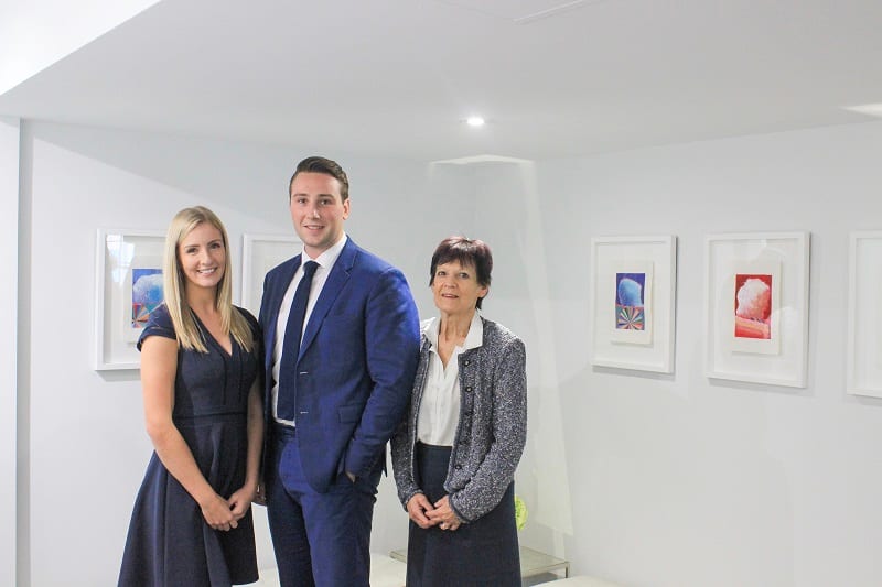 Three colleagues from Stoner & Company Family Law standing together in the firm's office